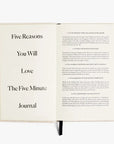 An open Five Minute Journal by Intelligent Change showcases a list titled Five Reasons You Will Love The Five Minute Journal, detailing its simplicity, positive psychology, and ease of creating a journaling habit. This 264-page undated planner features a black ribbon bookmark.