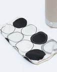 The Nightshade Concentric Circles shade lays next to the Nightside NS01 task lamp on a white table surface.