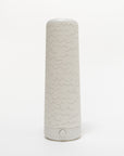 A tall, cylindrical water bottle with a white background features a simple wavy line pattern, a white lid, and a button near the base, showcasing minimalistic elegance reminiscent of the refined design seen in Nightsides Cursive Lines Cotton Shade.