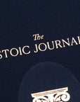 Navy blue cover of The Stoic Journal by Intelligent Change, a guided daily journal with gold text and a partial decorative column design at the bottom, inspired by Stoic philosophy.