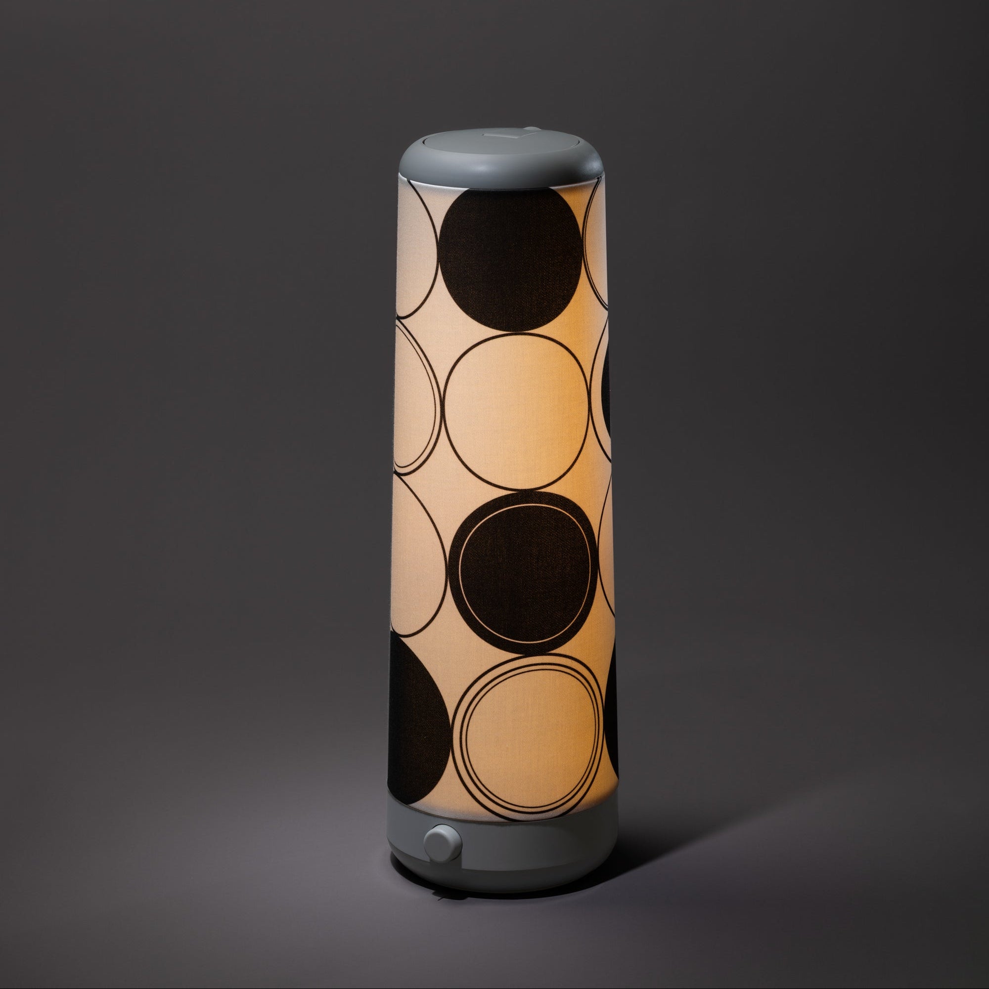 The Nightside Concentric Circles Cotton Shade features large black and outlined circles, casting a warm glow. Shade only; lamp base not included.