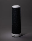The Nightside Starlight Cotton Blackout Shade, shown with a bold constellation-patterned black fabric on a dark gray background, features interchangeable shades to match any blackout shade or décor style.