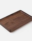 The Ugmonk Valet Tray - Large is a rectangular walnut tray with raised edges and a smooth, matte finish, precision milled for quality, shown against a plain white background.