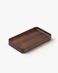 The Ugmonk Valet Tray - Small is a rectangular, shallow tray crafted from dark walnut with a matte finish and rounded corners, shown on a plain white background.