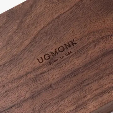 Close-up of the handcrafted Valet Tray - Walnut Small by Ugmonk, featuring Nightside and Made in USA engravings. The solid walnut piece showcases a rich, dark brown grain, emphasizing its quality craftsmanship.
