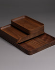 The Ugmonk Valet Tray Bundle features three handcrafted solid walnut trays in varying sizes, stacked to display their smooth, rounded edges and natural grain—an elegant solution for organizing your essentials.