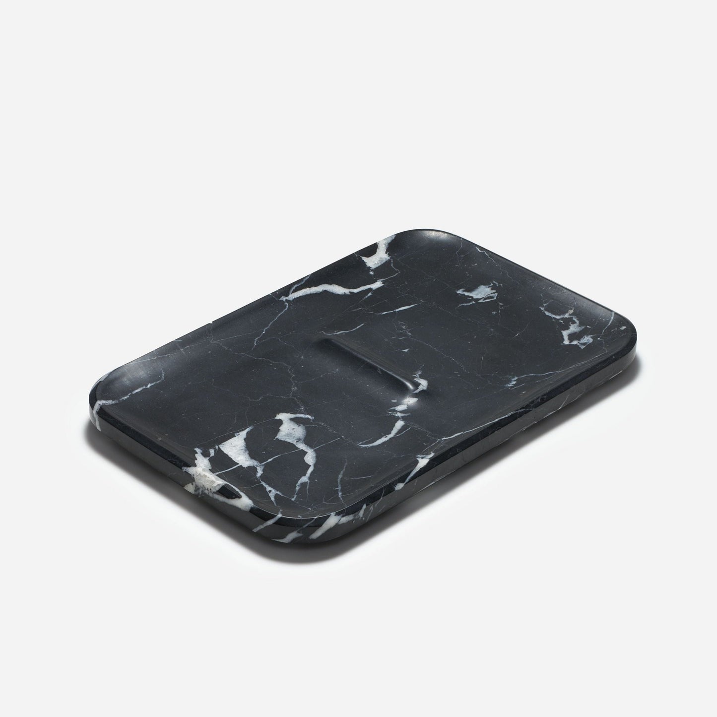 The Craighill Marble Nocturn Catch is elegantly displayed on a plain white background, highlighting its rectangular shape, black marble finish with rounded edges, and distinctive white veining.