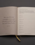 The Best Year Journal by Intelligent Change features an open spread: one page has a Brené Brown quote—“We can choose courage or we can choose comfort, but we can’t have both”—and the other offers prompts for mindful reflection on challenges and lessons.