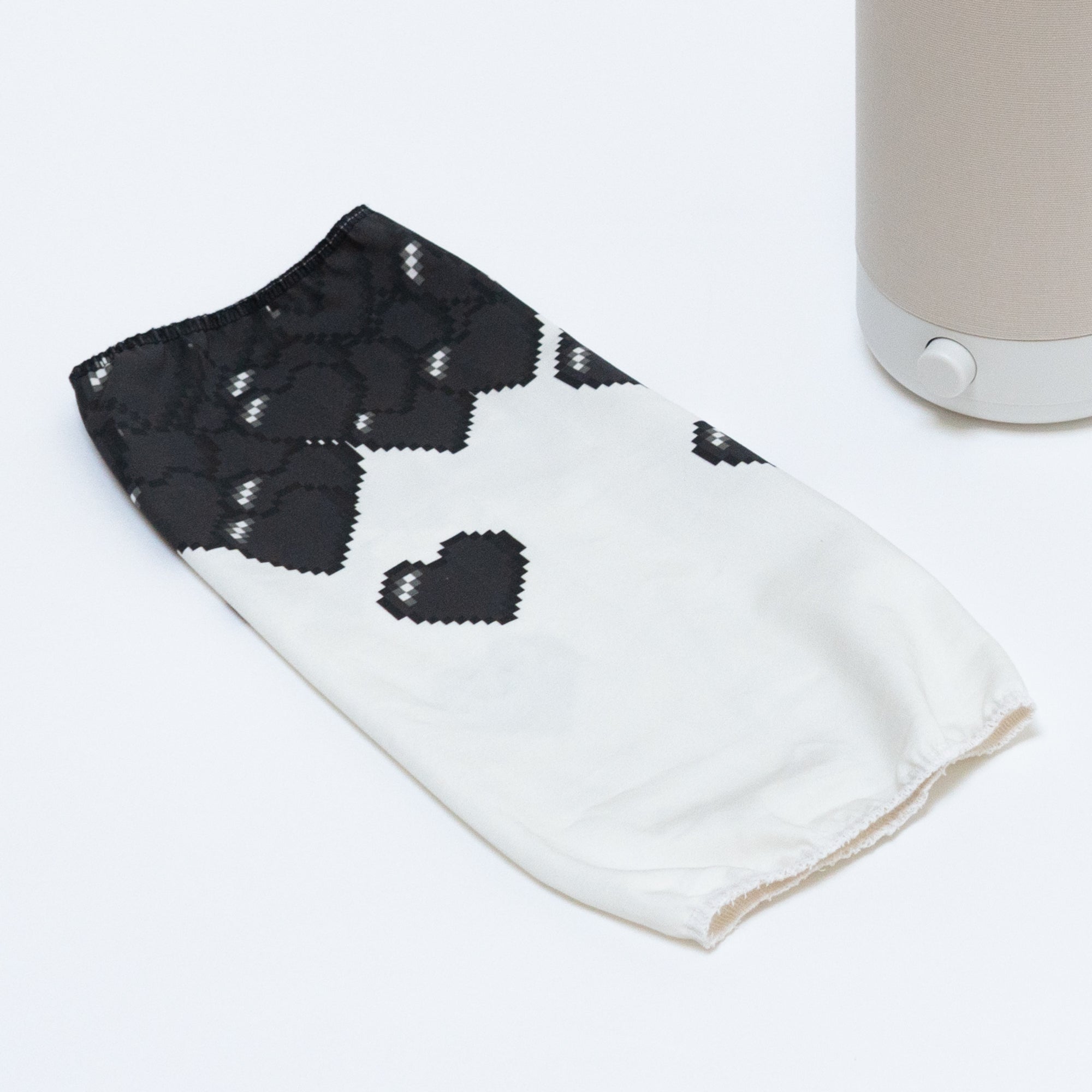 The Nightside 8-bit Hearts Cotton Shade is a white fabric cover with black heart patterns, designed for a blackout effect.