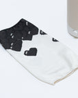 The Nightside 8-bit Hearts Cotton Shade is a white fabric cover with black heart patterns, designed for a blackout effect.