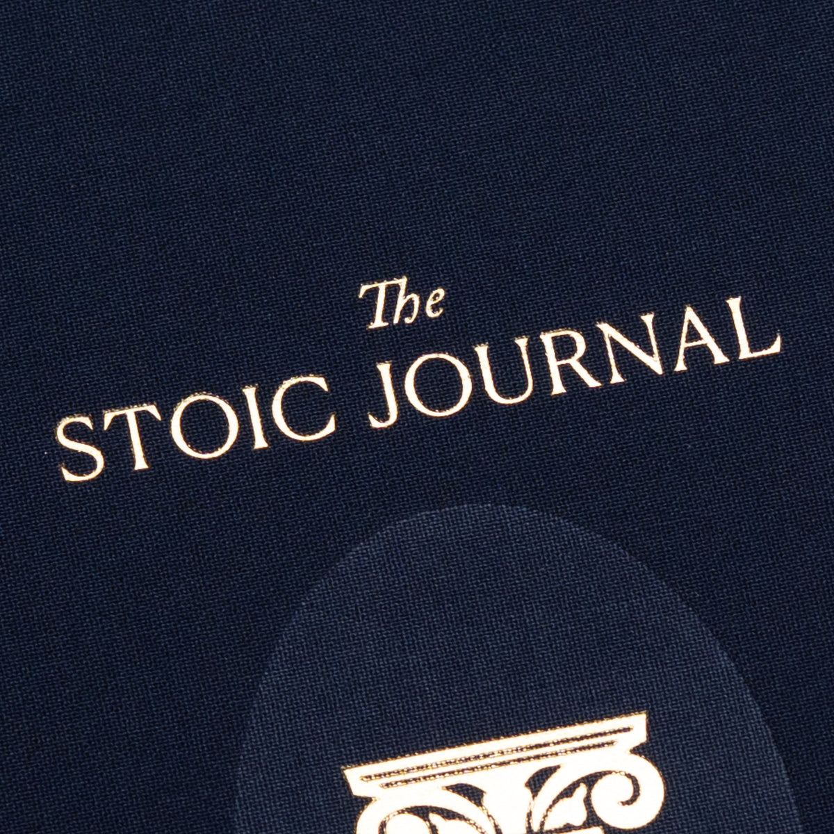 Navy blue cover of The Stoic Journal by Intelligent Change, a guided daily journal with gold text and a partial decorative column design at the bottom, inspired by Stoic philosophy.