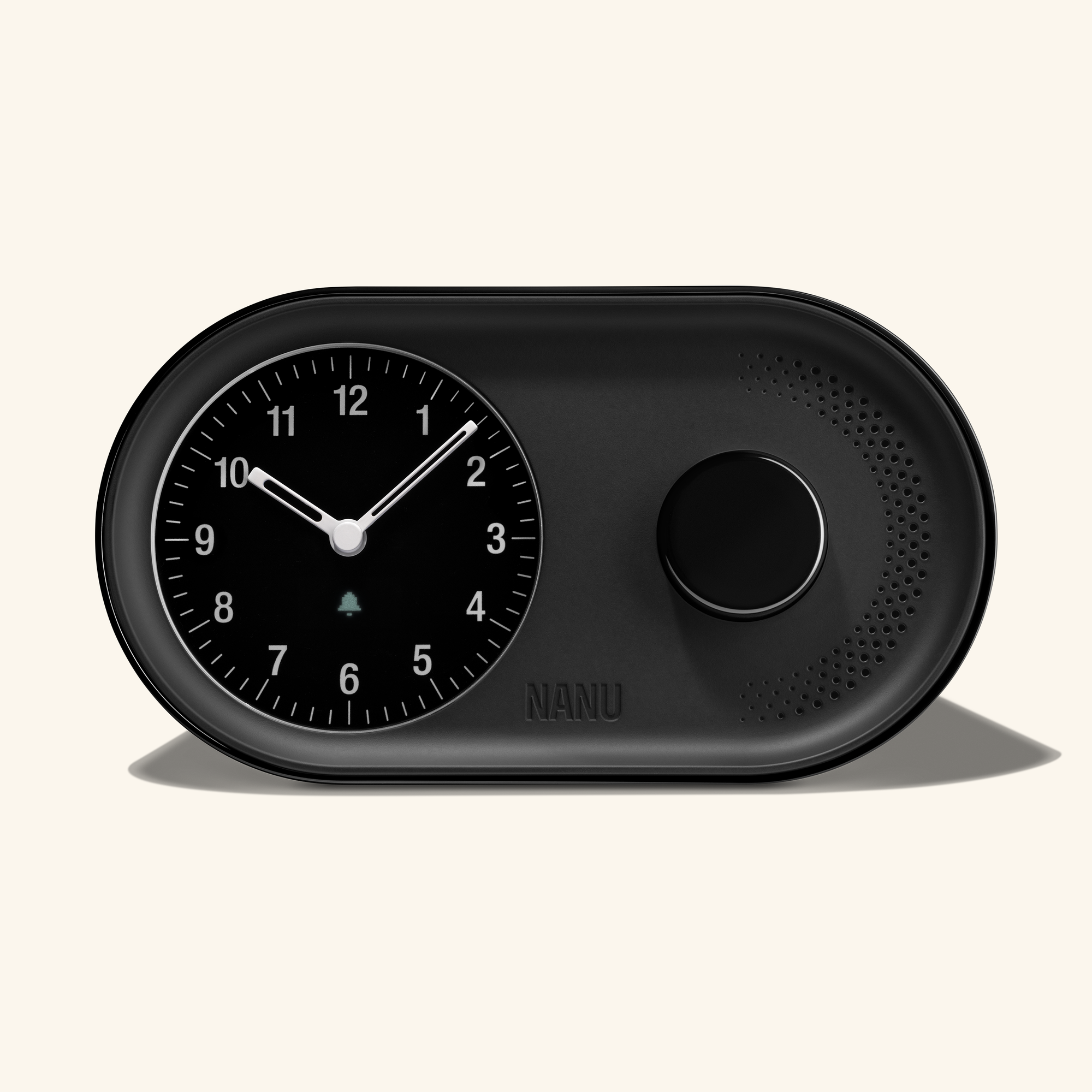 The Arc Alarm Clock by Nanu is a sleek black analog-style alarm clock with an analog face on the left and a round speaker grid on the right, displaying 10:11. It features gentle wake-up functionality and has Nanu elegantly embossed below the speaker, embodying timeless style.